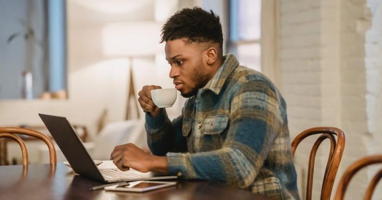 A man considering the costs of owning a home.